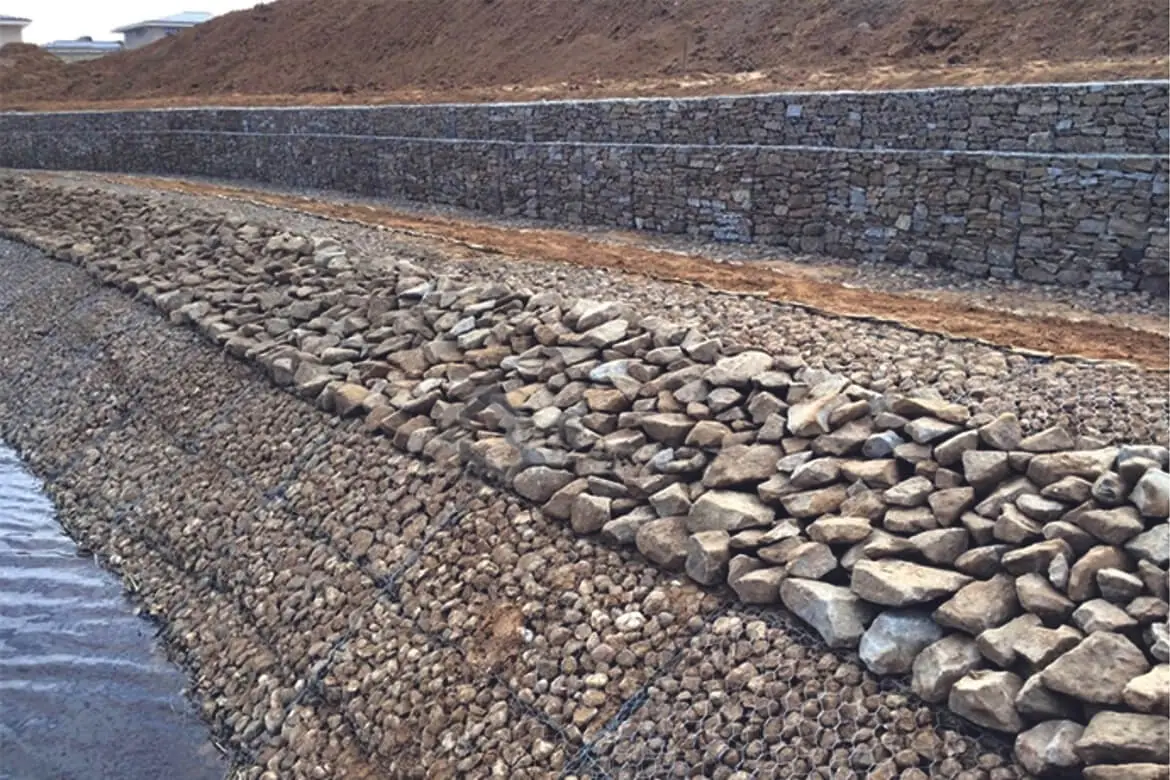 Riprap rock revetment protecting a freshwater lake shoreline.